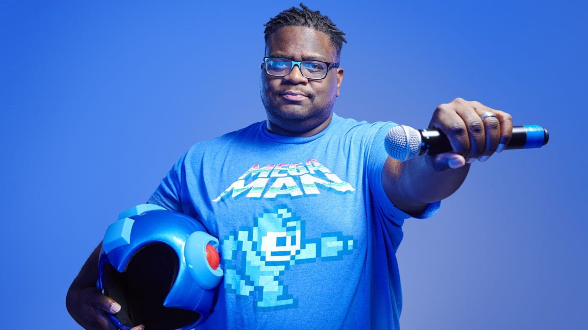 Mega Ran holding out a microphone