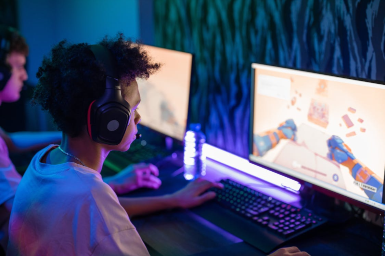 A young man playing a video game on a PC