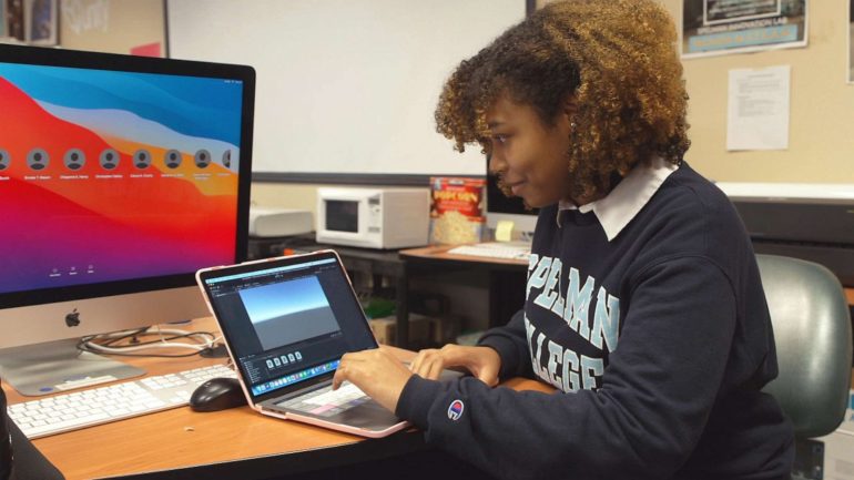 Spellman student Madeline Brown showing a game that she's developing on her laptop.